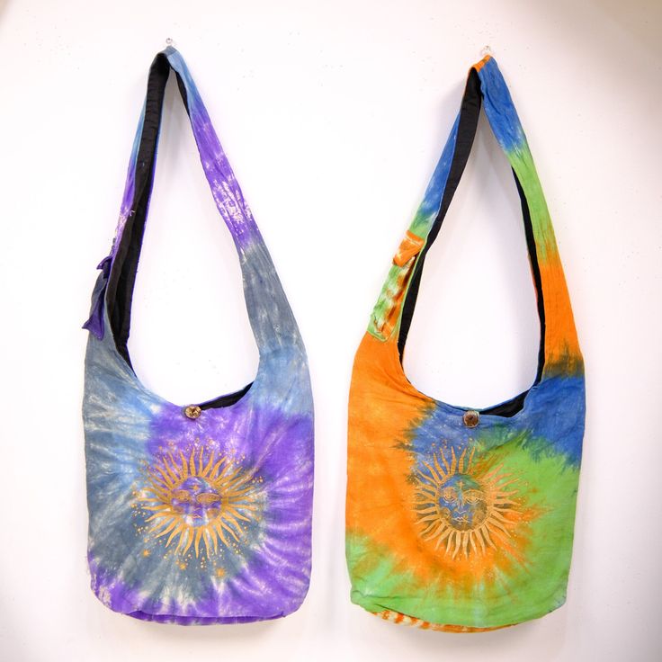 Tie Dye Cotton Messenger Bag, Whimsical Boho Crossbody Bag, Colorful Festival Sling, Hippie Hobo Bag, Colorful Beach Crossbody Handmade Bag  Unlock your inner free-spirit with this handmade, unisex messenger bag. Featuring a classic, tie-dye sun design and whimsical style, it's perfect for festivals, travelers, and anyone who loves the carefree and bohemian look. Handmade in Nepal Material: Organic Cotton This cotton messenger bag has a zipper closure and one smaller internal zip pocket Cotton inner lining One outer Strap Pocket with a velcro fastener where you can store your phone width: Approx. 16 inches Height: Approx. 15 inches Total Bag Length: Approx. 38 inches **ETHICALLY SOURCED **FAIRTRADE **SUSTAINABLE FASHION Multicolor Shoulder Beach Bag For Festivals, Festival Multicolor Shoulder Beach Bag, Multicolor Festival Shoulder Beach Bag, Multicolor Hippie Bag With Adjustable Strap, Hippie Multicolor Bag With Adjustable Strap, Hippie Multicolor Bags For Festival, Hippie Multicolor Shoulder Bag With Adjustable Strap, Hippie Multicolor Shoulder Bag For Festival, Multicolor Hippie Bag For Festivals