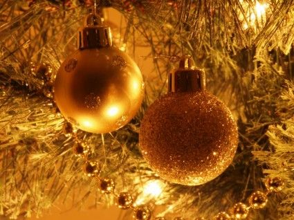 two christmas ornaments sitting on top of a table