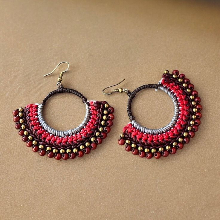 Macrame Boho Earrings Add a pop of boho style to your outfit with these stunning macrame boho earrings! The intricate knotting technique creates a unique and eye-catching design that is sure to turn heads. Featuring beautiful red, grey, brown and bronze colors, these earrings will complement any look. Handcrafted with care, these earrings are comfortable to wear all day long. Upgrade your accessory game with these must-have macrame earrings.  Made of macrame and high quality brass. A pair of ear Bohemian Adjustable Macrame Tassel Earrings, Red Bohemian Macrame Jewelry, Adjustable Macrame Beaded Earrings, Handmade Red Hoop Earrings For Beach, Handmade Bohemian Multicolor Wrap Earrings, Red Bohemian Hoop Earrings For Beach, Bohemian Red Hoop Earrings For Beach, Bohemian Adjustable Wrap Earrings For Festival, Adjustable Red Handwoven Earrings