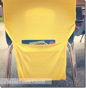 a yellow chair with a laptop in it's pocket on the carpeted floor