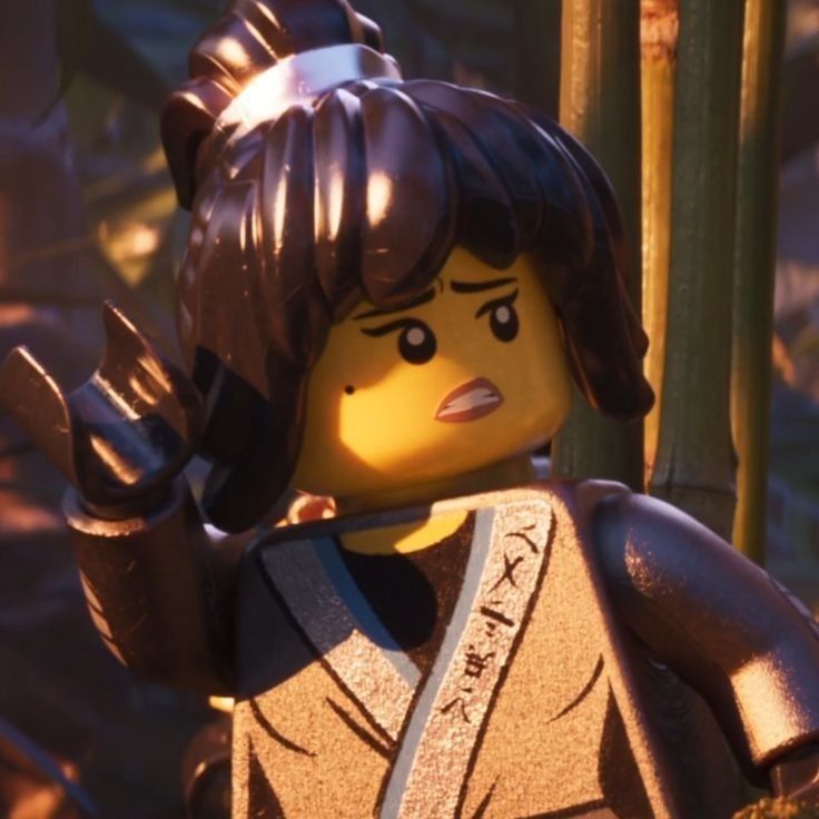 the lego movie character is holding his hand up in front of some bamboo stalks and trees