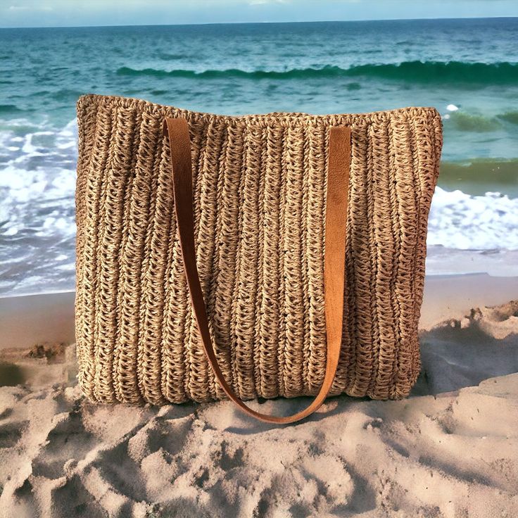 Any woman must have this bag for every fashionista. Whether you keeping it to yourself or gifting someone you care, it will be unforgettable. ✔️I made this beautiful bag from natural paper rope which is organic cotton and vegan leather in tan. ✔️The interior of the straw summer bag has a magnetic button. Suitable for use as handbag, market bag, beach bag or party bag. ✨Handmade products ✨Natural raffia yarn ✨Ultra-careful craftsmanship  ✨High-quality special products for you  ✔️You can combine your clothes with a straw summer bag on summer days ✔️This bag has a packable form and does not take up space in the suitcase. Unique for holidays ! ✔️Handcrrafted in Turkey ✔️Hand-crocheted with care ✔️This bag is light weight yet durable, breathable and environmental at the same time. Width: 45 cm Chic Straw Bag For Everyday Vacation Use, Chic Straw Bag For Vacation And Everyday Use, Eco-friendly Sand-colored Shoulder Bag For Vacation, Beachy Everyday Sand-colored Bag, Everyday Sand-colored Straw Tote Bag, Trendy Jute Crochet Bag For Beach Season, Sand-colored Shoulder Bag With Braided Handles For Travel, Trendy Jute Crochet Bag For Vacation, Trendy Handwoven Bags For Vacation