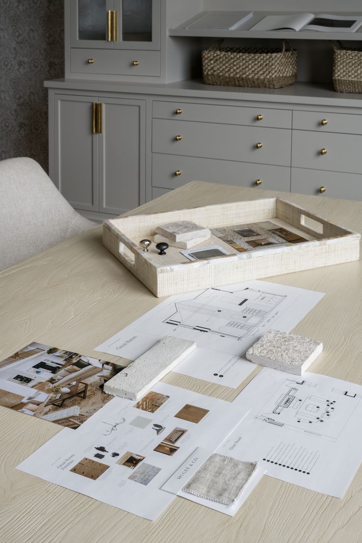 a wooden table topped with lots of papers