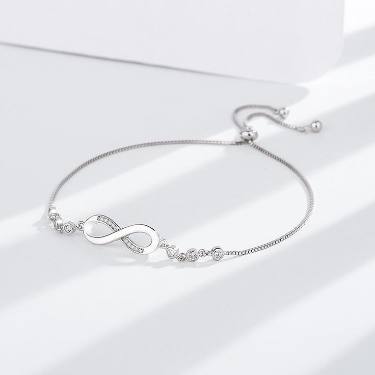 💎 Elevate Your Style with Sterling Silver: Choose the Silver-S925 option and experience the timeless beauty of the S925 Infinite Bracelet. Crafted from high-quality S925 sterling silver, this bracelet is not just jewelry; it's a symbol of everlasting connection and elegance. Classic Silver Diamond Bracelet As A Gift, Timeless Silver Diamond Bracelet As Gift, Timeless Sterling Silver Diamond Bracelet For Anniversary, Elegant Personalized Adjustable Diamond Bracelet, Adjustable Silver Chain Bracelet Fine Jewelry, Minimalist Sterling Silver Diamond Bracelet For Anniversary, Timeless Silver Chain Bracelet With Cubic Zirconia, Timeless Silver Bracelets For Anniversary, Elegant Silver Name Bracelet Hypoallergenic