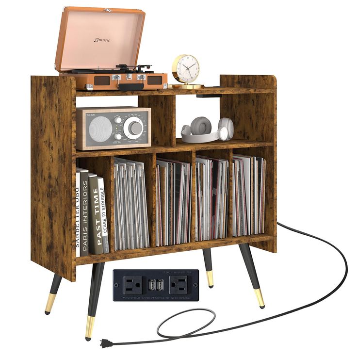 an old fashioned record player is hooked up to a bookcase with cd's on it