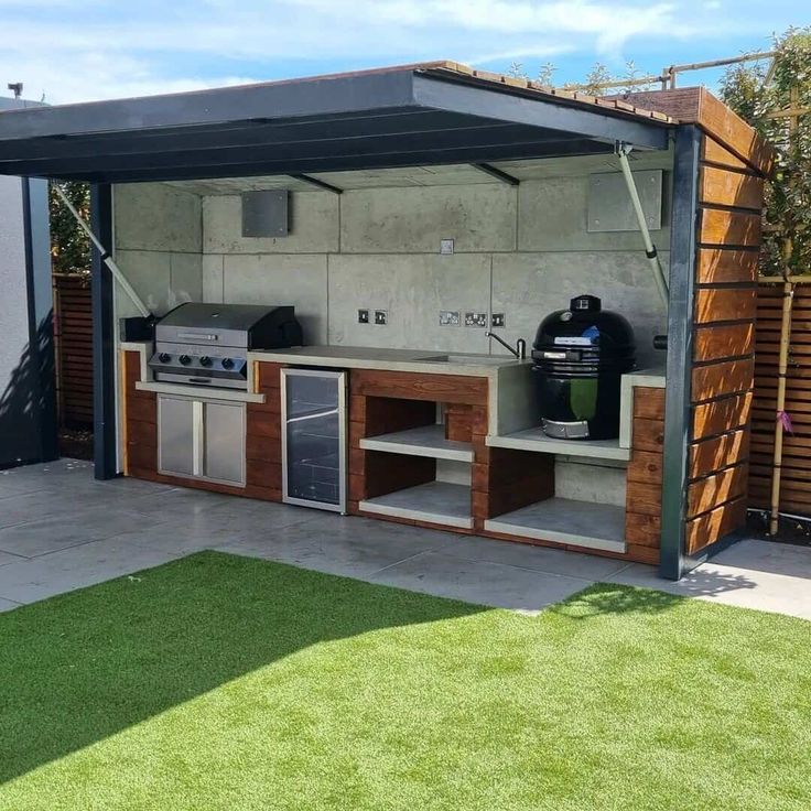 an outdoor kitchen is built into the side of a house