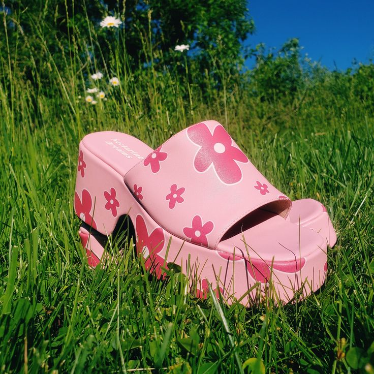 Transform your look with the Pink Haze Platform Sandals and step into a world of retro charm and modern comfort. Featuring a vibrant pink floral print, these open-toe sandals are perfect for channeling 70's vibes while the chunky, cushioned design keeps you comfortable and stylish all day long. Retro Floral Print: Eye-catching pink floral pattern for a fun, vintage-inspired look. Open-Toe Design: Perfect for showcasing your pedicure and keeping cool. Chunky Platform: Adds height while providing Spring Chunky Platform Open Heel Slippers, Pink Slide Platform Slippers For Spring, Summer Chunky Platform Slide Sandals, Pink Platform Slide Slippers For Spring, Spring Chunky Platform Sandals, Pink Open Toe Slides For Summer, Spring Chunky Platform Open Toe Slides, Trendy Spring Platform Slippers, Spring Chunky Platform Slide Wedge Sandals