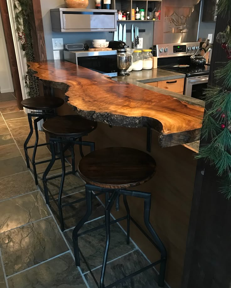 three stools are sitting at the bar