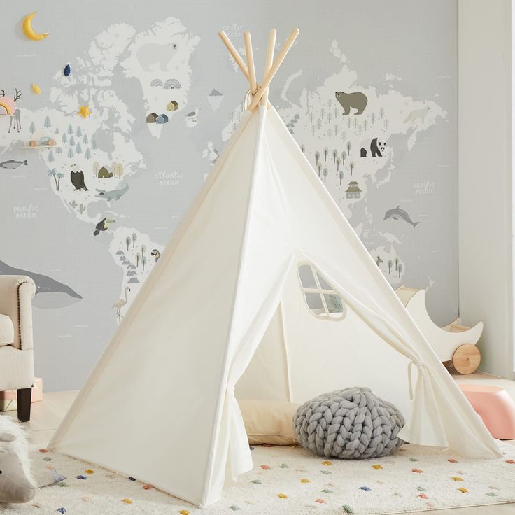 a teepee tent sitting on top of a rug in a child's room