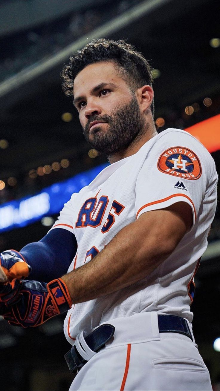 a professional baseball player is holding his glove