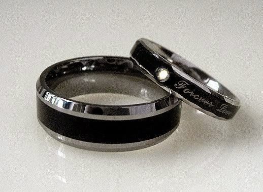 two black and white wedding bands with the words love written on them