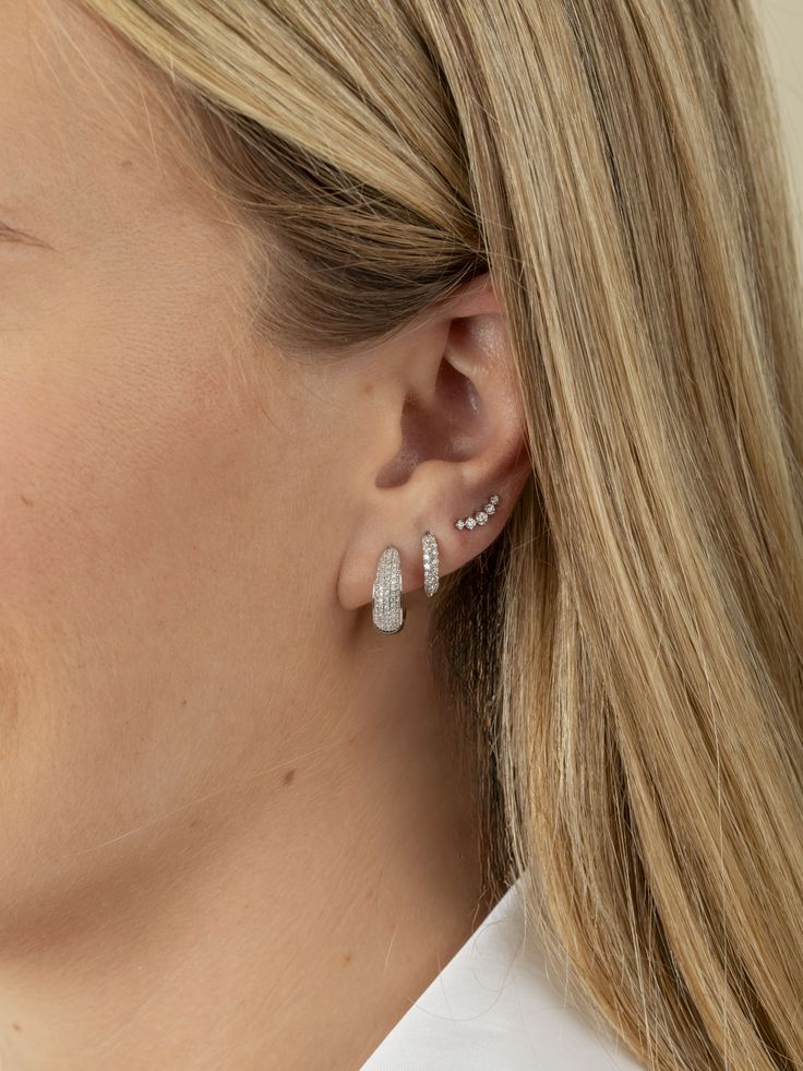 Add a touch of chic sparkle with our Kelly Climber Stud Earrings. These graduated diamond studs are designed in a graceful curved shape, making them perfect for second or third piercings. Crafted to enhance your everyday style, these earrings offer a playful yet elegant look that’s both versatile and irresistibly cute. Diamond Accented Piercings For Anniversary, White Gold Piercings With Matching Earrings, Elegant White Gold Piercings, Everyday White Gold Ear Cuff, Classic Diamond Cartilage Earrings, Fine Jewelry Piercings With Diamond Accents, Elegant Piercings With Diamond Accents, Elegant White Gold Huggie Ear Cuff, Diamond Single Ear Climber Fine Jewelry