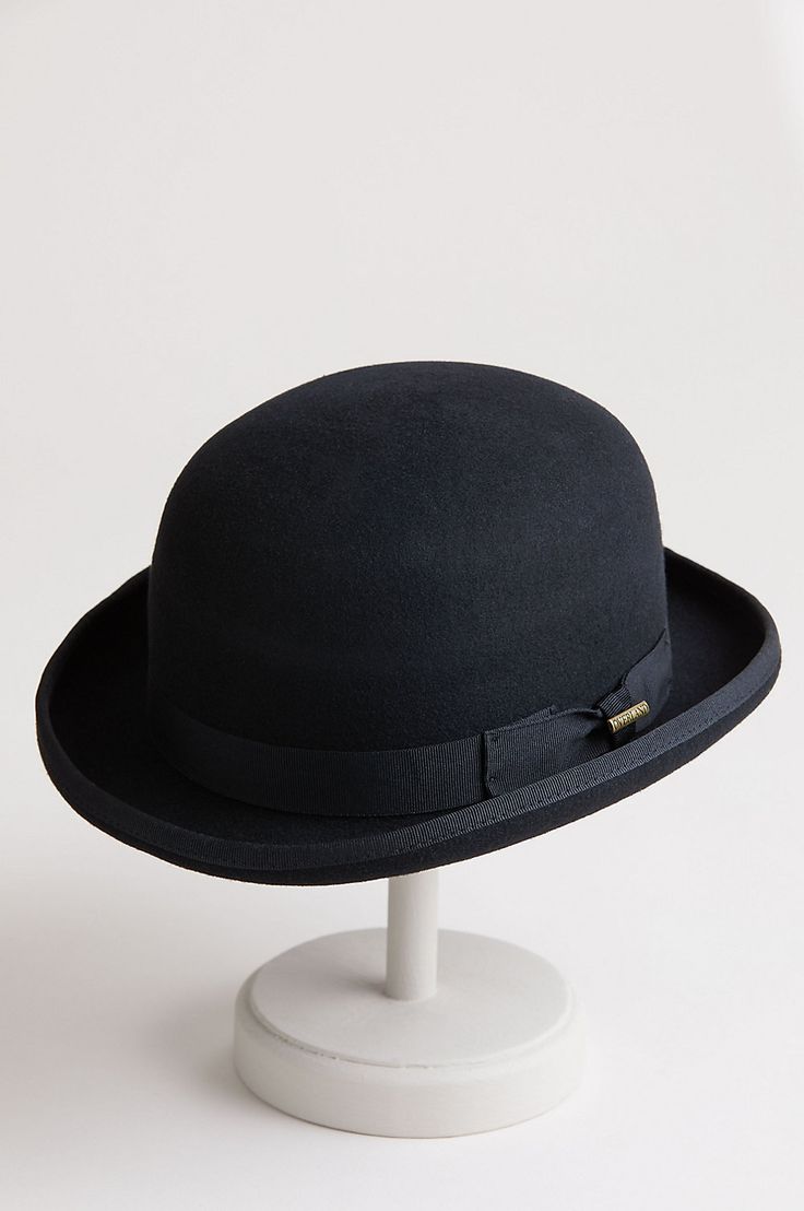 Top off your seasonal presentation with the charming Wool Bowler. Fashioned in 100% wool felt with its signature 3 3/4" tall dome crown and a wide grosgrain bow trim with pin, this classic design boasts a bound edge brim with a signature shape that's structured and curved. On the inside, there's a pleated satin lining, a clear plastic barrier, and a smooth comfort sweatband for a snug fit. Dare to look dashing. Classic Fall Hat, Classic Top Hat For Fall, Classic Fitted Hat Bands For Fall, Classic Fitted Top Hat For Fall, Classic Solid Cloche Hat For Fall, Classic Fitted Felt Hat With Short Brim, Classic Wool Top Hat For Fall, Classic Wool Felt Hat For Winter, Classic Solid Color Cloche Hat For Fall