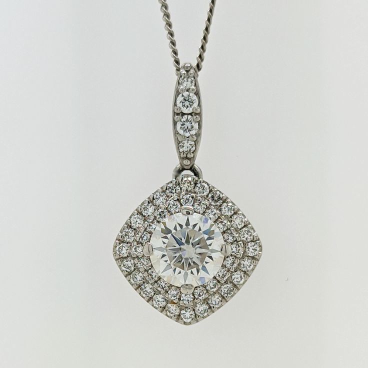 This piece is luxuriously crafted in solid 14k white gold and the natural diamonds radiate gracefully from the mounting. They also beautifully highlight the gorgeous round center colorless moissanite.   Add shimmer to your day or evening look with this double halo moissanite & diamond pave pendant.  The chain is included in the price. * Description: *Length: 13mm (without bail) * Metal purity: solid 14k white gold *Center Stone:6.5mm (DEW 1ct) moissanite * Center Stone Quality: VS-VVS clarity an Dazzling Diamond White Lab Grown Diamond Necklace, Diamond White Brilliant Cut Cubic Zirconia Necklace, Exquisite Platinum Diamond Necklace Vvs Clarity, Exquisite Platinum Diamond Necklace With Vvs Clarity, Diamond White Moissanite Jewelry With Single Cut Diamonds, Dazzling Round Cut Diamond Necklace, Dazzling Diamond White Necklace With Prong Setting, Dazzling Platinum Diamond Necklace With Round Cut, Exquisite White Gold Diamond Necklace With Brilliant Cut