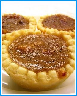 three small pies on a white plate with one cut in half to show the filling