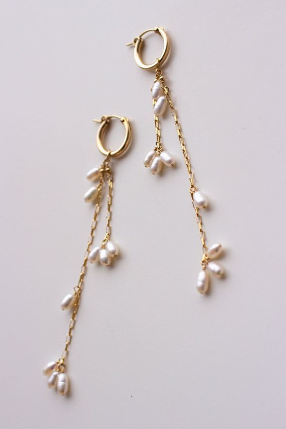 Completely handcrafted in our New York studio, the Falling Petals Mini Hoop Earrings feature genuine freshwater pearls. Lightweight and easy to wear. Wear them two ways - slide the dangle off to wear just the simple hoop earring. Ear wires: hoop Materials: 14k Gold Filled or Sterling Silver Measures approx. 3 3/4" (longest strand) in length Handmade in New York Arrives in a keepsake clutch and box Gold Earrings With Pearls, Simple Earrings Design, Easy To Make Earrings, Handmade Drop Earrings, Handmade Earrings Ideas, Pearl And Gold Earrings, Handmade Jewelry Ideas, Handmade Pearl Earrings, Simple Gold Jewelry