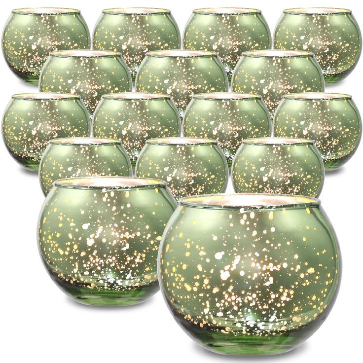 green glass vases with gold speckles are lined up against a white background