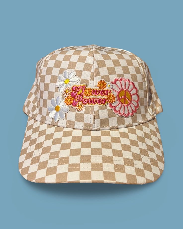 Upgrade your spring and summer style with our Flower Power Checked Cap. This white and tan checkered baseball cap features floral and heart patches for a playful yet stylish look. Get ready to rock your flower power vibes with this quirky and fun accessory! A Cactus Jane Original, made in house at our Laguna Beach store front Retro Spring Baseball Cap With Curved Brim, Retro Curved Brim Baseball Cap For Spring, Vintage White Trucker Hat For Spring, Vintage Baseball Cap With Curved Visor For Spring, Trendy Spring Hats With Curved Visor, Retro Curved Bill Hats For Spring, Trendy Curved Visor Hats For Spring, Trendy Spring Hat With Curved Visor, Playful Cotton Baseball Cap For Spring