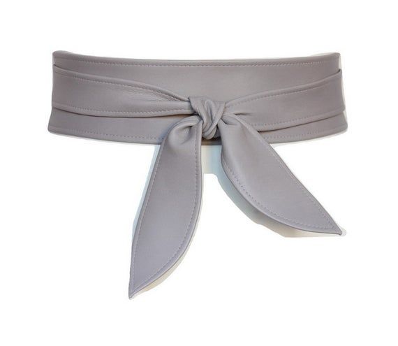 Taupe Leather Obi belt Petals style Women's belt leather soft genuine leather Cinch wrap beltMade of premium quality leather. 100% handmade.Unique and simple design. Quality craftsmanship.The material is soft and comfortable to wear. Pure  leather, with natural shadings and scars.*IMPORTANT SIZING TIP:When selecting the size you need, please select the size that fits your waist measurement and you will be able to tie a simple knot because the both ends will be 5" - 8" long.  If you want a rich b Elegant Leather Corset Belt For Spring, Adjustable Chic Corset Belt For Spring, Chic Adjustable Corset Belt For Spring, Elegant Spring Corset Belt, Fitted Belts With Sashes For Spring, Elegant Adjustable Leather Corset Belt, Adjustable Formal Sash Belt, Adjustable Elegant Corset Belt, Elegant Adjustable Corset Belt