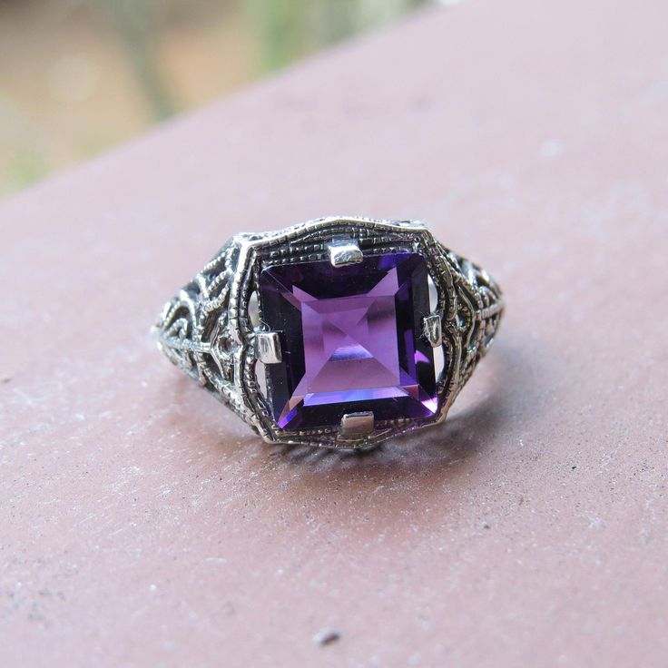 Vintage Sterling Silver Princess cut Amethyst Filigree Ring ...Marked 925...Total of weights 3.4grams...Size 8...Measure of Face 12.9MM...It's in very good condition. Purple Sterling Silver Filigree Jewelry, Classic Purple Sterling Silver Ring, Classic Amethyst Purple Rings, Classic Purple Ring As Gift, Classic Purple Gemstone Birthstone Ring, Classic Purple Rings As Gift, Classic Purple Birthstone Ring With Gemstone, Heirloom Purple Rings With Accent Stones, Antique Purple Amethyst Ring With Accent Stones