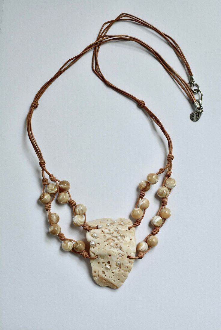 Shell hand-picked by me on the Mexican Gulf shore. I cleaned and polished it, attached mini pearls and put it on a leather strap with 20 mother of pearl beads and metal lobster clasp. Necklace length 28" when open and stretched lengthwise from tip to tip Affordable Adjustable Mother Of Pearl Shell Necklace, Luxury Unique Mother Of Pearl Shell Necklace, Adjustable Shell Jewelry With Pearl Charm, Adjustable Shell-shaped Jewelry With Pearl Charm, Adjustable Multi-strand Beige Necklaces, Adjustable Multi-strand Beige Necklace, Adjustable Shell Necklace With Pearl Charm, Adjustable Shell-shaped Pearl White Jewelry, Adjustable Pearl White Shell Jewelry