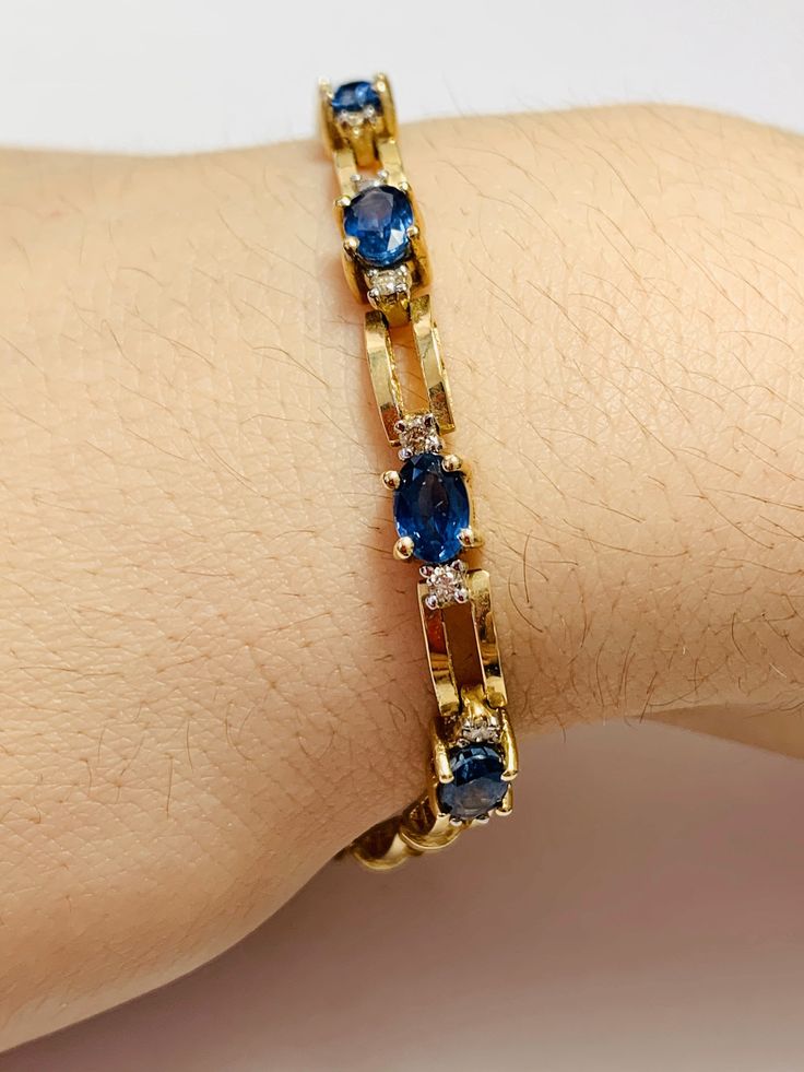 Beautiful Vintage 14K Yellow Gold Diamond and Oval shape Sapphire Bracelet: Stunning Genuine Diamonds and Natural Oval Sapphires Sapphire(s): 11 pc 8.0 CT Diamond(s): 0.20 CT Color: F Clarity: SI1 Total Bracelet Weight: 11.1 GR Bracelet Length: 7in Bracelet Width: 5 mm 14K Yellow Gold For more information regarding this item feel free to reach me so I can accommodate your needs. Thank you Formal Oval Gold Bracelet With Diamond Accents, Oval Gold Bracelet With Gemstone For Formal Occasions, Oval Gold Gemstone Bracelet For Formal Occasions, Formal Oval Gold Bracelet With Gemstones, Formal 14k Gold Hand Set Bracelets, Formal Oval Gold Gemstone Bracelet, Elegant Blue Diamond Bracelet In 14k Gold, 14k Gold Tennis Bracelet With Gemstones For Formal Occasions, Blue Gold Bracelet With 17 Jewels For Formal Occasions