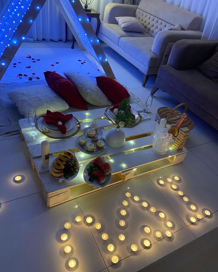 a living room filled with lots of furniture and candles on top of a tray covered in lights