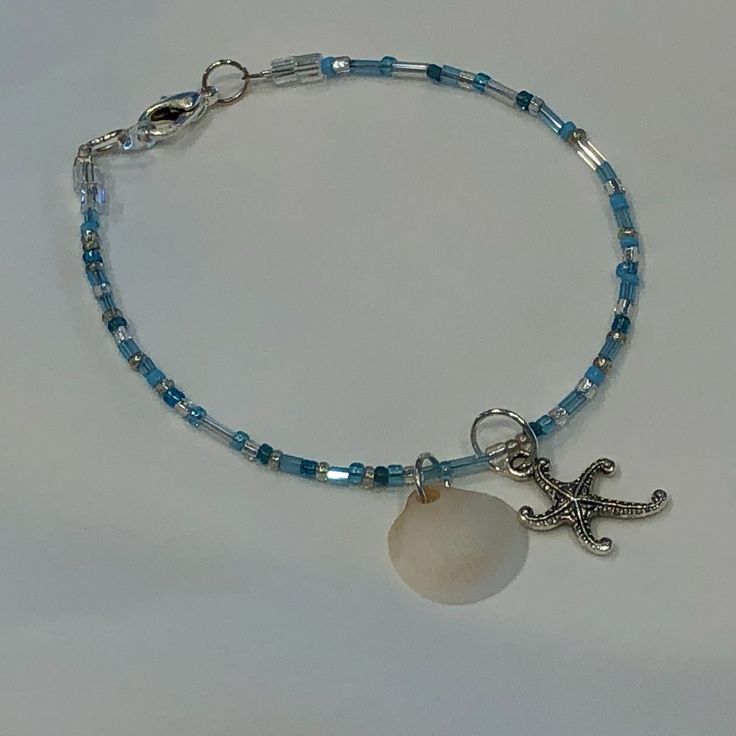 Beach Beauty Beaded Bracelet Blue, Turquoise & Clear Seed & Tube Beads With A North Carolina Seashell And Starfish Charms The Bracelet Measures 7.75" Coastal Cutie!!!!! New, Handmade By Me, With Love, For You!! (Please See The Beautiful Matching Necklace Listed As Well) Starfish-shaped Beaded Beach Jewelry, Coastal Blue Beaded Jewelry, Turquoise Beaded Bracelets With Starfish Charm, Blue Beaded Beachy Jewelry, Adjustable Blue Jewelry With Starfish Charm, Starfish-shaped Beaded Jewelry For The Beach, Adjustable Blue Starfish Jewelry, Blue Bracelets With Starfish Charm And Round Beads, Blue Beaded Bracelet With Starfish Charm