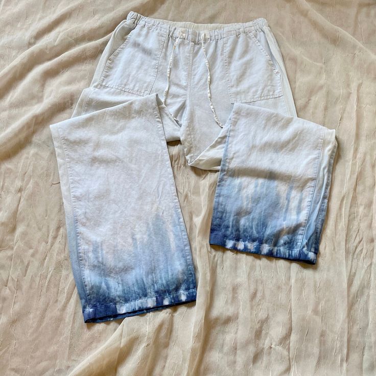 "These breezy linen pants are accented with a dip-dye hem along the bottome. Great construction with a few orange details. -Dimensions- Tag Size: M Waist: 16\" Crotch: 13\" Length: 40\" from waistband, 27\" from crotch" Indigo Cotton Pants For Summer, Summer Cotton Pants In Indigo, Summer Indigo Cotton Pants, Relaxed Fit Wide Leg Bottoms Pre-washed, Summer Washed Cotton Pants, Casual Tie-dye Straight Leg Bottoms, Tie Dye Cotton Straight Leg Bottoms, Spring Straight Leg Hand Dyed Bottoms, Acid Wash Straight Leg Bottoms For Summer