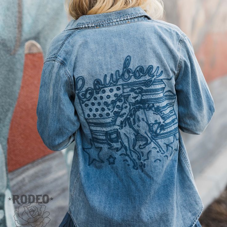 Patriotic Cowboy Button Up by Rodeo Quincy is a cute denim shirt with the design embroidered in blue on the back. Made of denim, it can be dressed up or down for any occasion. With pearl snap buttons, this button up exudes a timeless and sophisticated appeal. True to Size Embroidered Denim Fabric Western Blouse, Western Style Shirt, Outfit Shop, Embroidered Denim, Embroidered Design, Western Style, Country Girls, Denim Fabric, Denim Shirt