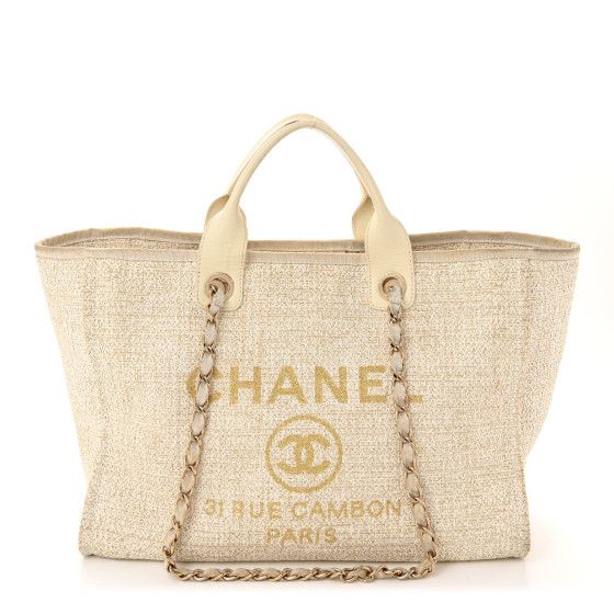 This is an authentic CHANEL Canvas Large Deauville Tote in Ivory. This stylish tote is crafted of fine canvas in white with gold printed Chanel Rue Cambon Paris logo. It features rolled leather top handles andfabric threadedgold chain shoulder straps. The top is open toa light beige fabric interior with zipper and patch pockets. Chanel Rue Cambon, Chanel Canvas, Paris Logo, Beige Fabric, Gold Print, Cute Bags, Clothing Ideas, Light Beige, Leather Top