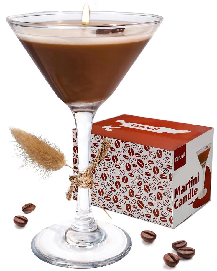 a chocolate martini in a glass with coffee beans around it and a carton of milk on the side