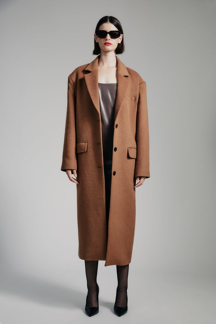 Intentional warmth. The Structured Oversized Camel Coat features a contemporary boxy fit in a longline shape with a notched lapel, shoulder pads, back vent, functional pockets and a three-button front.SIZING: Boxy fit. AU: Model wears a size 8 / US: Model wears a size 4.FABRICATION: Main: 52% polyester, 39% viscose, 9% elastane - Single breasted - Shoulder pads - Longline Oversized Brown Outerwear With Notch Lapel, Oversized Brown Wool Coat For Work, Modern Brown Outerwear With Button Closure, Brown Wool Outerwear For Everyday, Structured Brown Outerwear For Fall, Modern Structured Outerwear With Button Closure, Brown Long Coat Outerwear For Everyday, Modern Brown Single Breasted Outerwear, Brown Long Coat For Everyday Wear