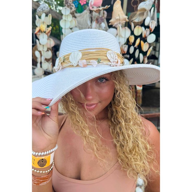 Introducing the Shell Trim Wide Brim Sun Hat - perfect for any sunny day! This fashionable hat not only provides protection from the sun's rays, but also adds a stylish touch to any outfit. With its wide brim and unique shell trim, you'll be ready for any summer adventure! * Circumference: 22 3/8" * Brim Size 3 7/8" * Crown: 3 3/4" * 80% paper, 20% polyester * UVA/UVB SPF 50 Protection Sun Hats With Uv Protection For The Beach, Sun Hat With Uv Protection For Beach Season, Brimmed Panama Hat For Sunbathing In Beach Season, Beachwear Sun Hat With Upf 50+ For Beach Season, Beachy Sun Hat With Uv Protection, Brimmed Panama Hat For Beach Season, White Straw Bucket Hat With Wide Brim, Upf 50+ Panama Hat For Sunbathing Beach Season, Upf 50+ Panama Hat For Beach Season Sunbathing