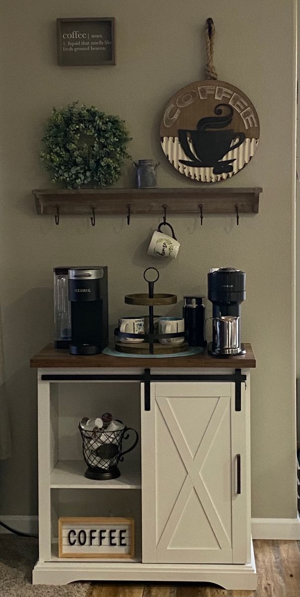 a coffee bar with two shelves above it and some cups on top of the table