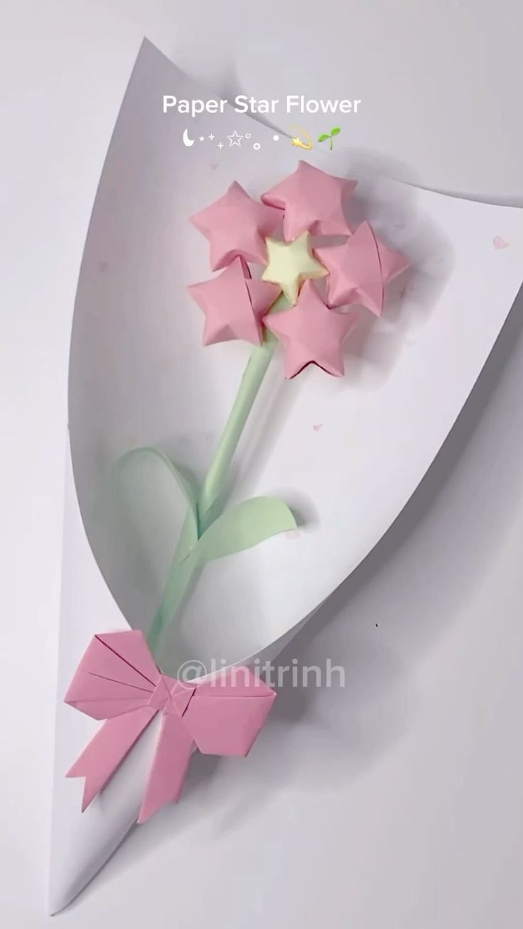 a paper star flower with pink flowers in it