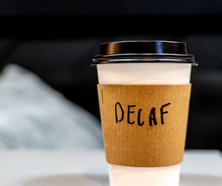 a coffee cup with the word decaf written on it