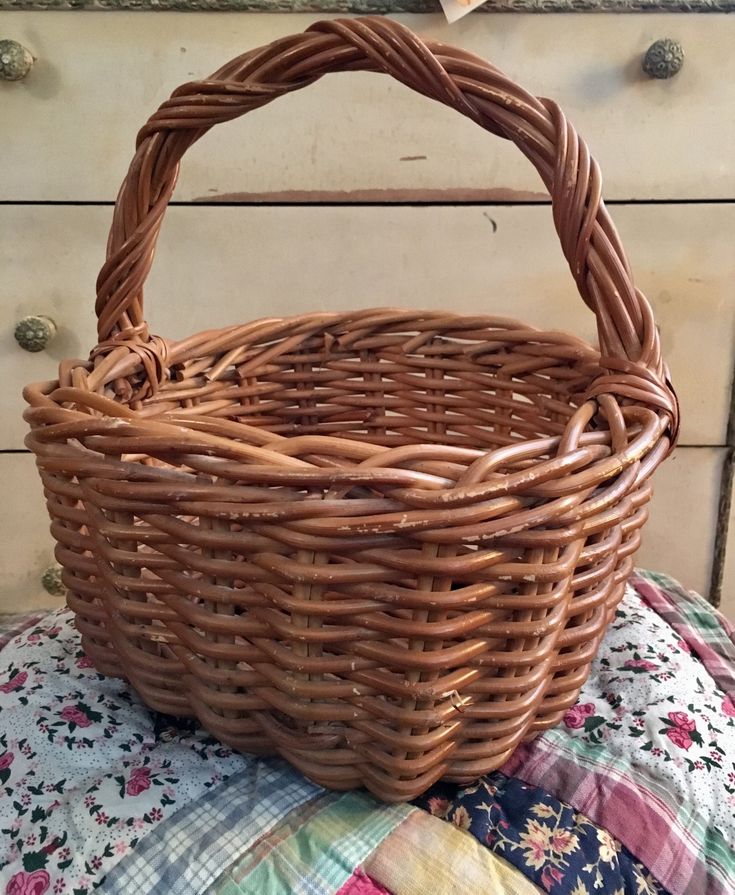 a wicker basket sitting on top of a quilt