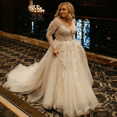 a woman in a wedding dress standing on the floor