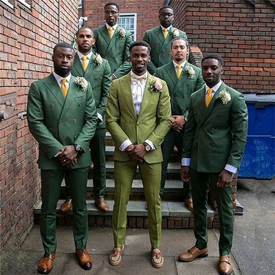 a group of men in green suits standing next to each other on some steps outside