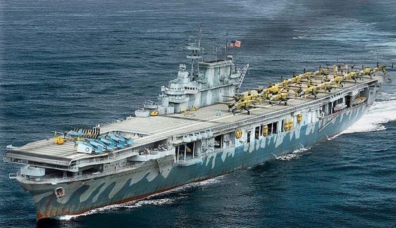 an aircraft carrier in the middle of the ocean