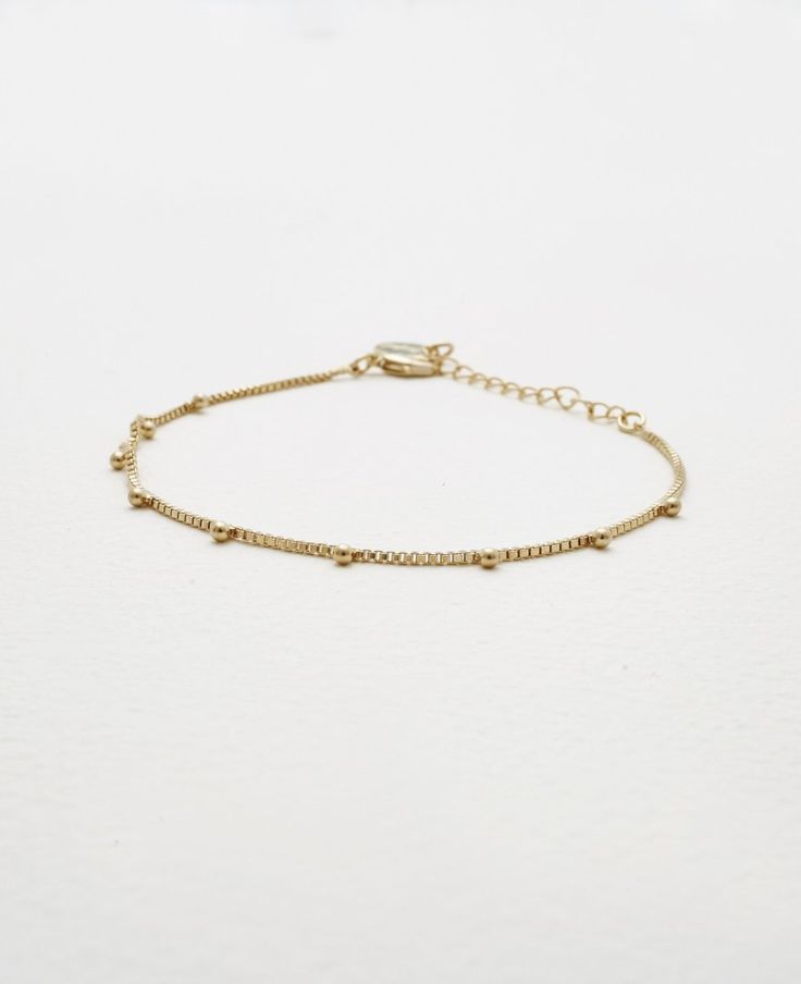 Slim and elegant bracelets never fail to impress us and we know every woman finds tons of uses for these in her collection. Meet all your dainty elegance goals with our Emery bracelet. The delicate design exudes tons of charm and femininity and will fit effortlessly into your hectic weekday dress-ups too.- Brass with Polyurethane Coating- Adjustable length of 7" to 9"- Available in Gold and Silver Elegant Anklets With Extender, Trendy Adjustable Gold Bracelet With Delicate Chain, Elegant Adjustable Metal Anklets, Dainty Metal Bracelet For Everyday, Dainty Everyday Metal Bracelets, Elegant Adjustable Anklets With Delicate Chain, Trendy Adjustable Charm Bracelet With Delicate Chain, Trendy Adjustable Delicate Chain Bracelet, Elegant Metal Anklet With Adjustable Chain