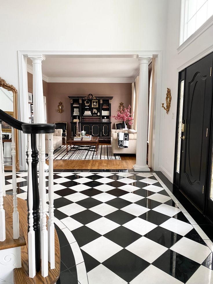 a black and white checkered floor in a living room next to a door way