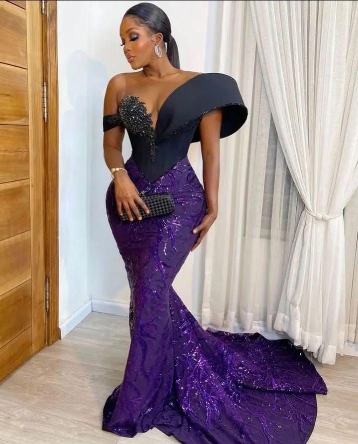 This Asoebi Corset Dress is perfect for any occasion! This exquisite evening dress is a must-have for Owanbe celebrations, traditional marriage events, and birthday parties.  Crafted with intricate details and made from high-quality fabric, this dress showcases the latest in trending Asoebi styles. Whether you're a wedding guest or celebrating a special milestone, the Asoebi Corset Dress will make you the center of attention. Shop now to secure your Asoebi Corset Dress and be ready to turn heads Purple Dresses For Banquet And Prom Season, Purple Fitted Dress For Banquet, Purple Mother Of The Bride Dress With Sweep Train, Fitted Purple Maxi Dress For Banquets, Elegant Fitted Purple Ball Gown, Glamorous Purple Gown For Banquet, Purple Fitted Floor-length Ball Gown, Glamorous Purple Banquet Gown, Purple Gown With Sweep Train For Banquet