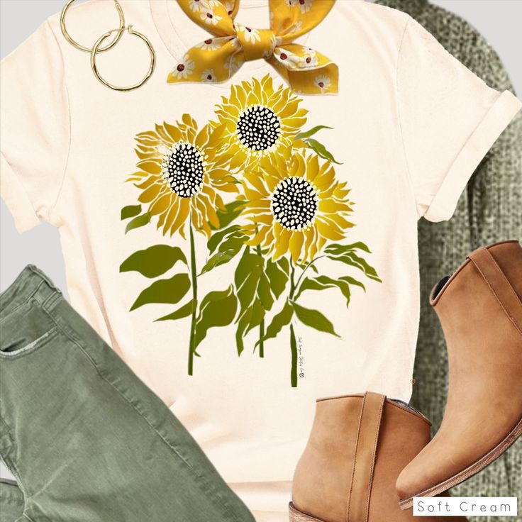 a t - shirt with sunflowers on it and some shoes next to it