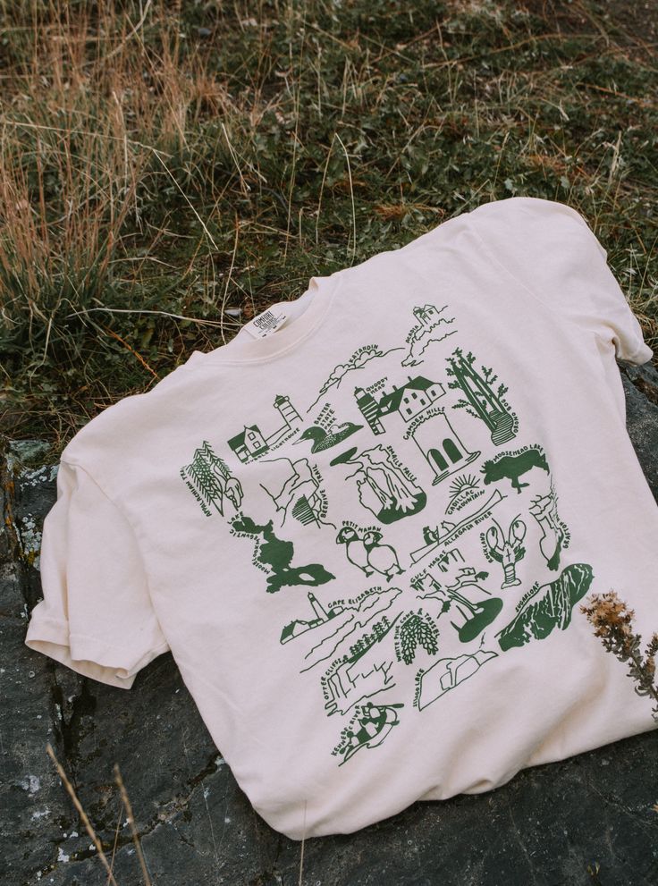 Our tribute to the nature in Maine! This design features lighthouses, major mountains, beloved wildlife, & 15+ other beautiful sites from the Allagash to Acadia. Let it remind you of the places you've been and inspire you to see the rest!  These will ship within 2 business days of ordering. If combined with a made-to-order item, we will default to shipping when your entire order is ready This listing has a measurement chart (please scroll through the photos); you can also reference any reviews a Maine Nature, White Pine Cone, Hiking Inspiration, Baxter State Park, Outdoorsy Gifts, Cape Elizabeth, Nature Shirts, Beautiful Sites, Granola Girl