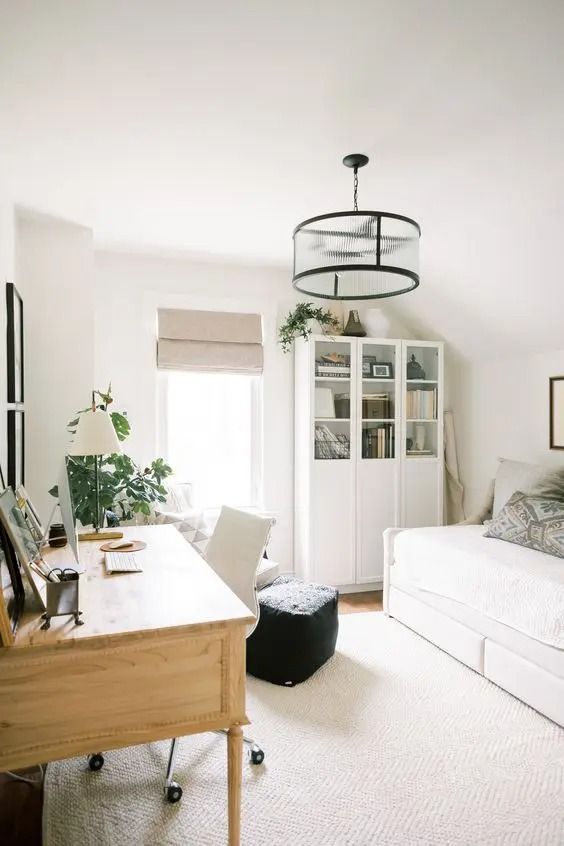 a living room with a couch, desk and bookshelf