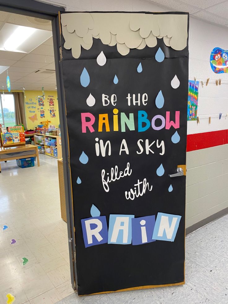 a classroom door with rain written on it and the words, be the rainbow in a sky filled with rain