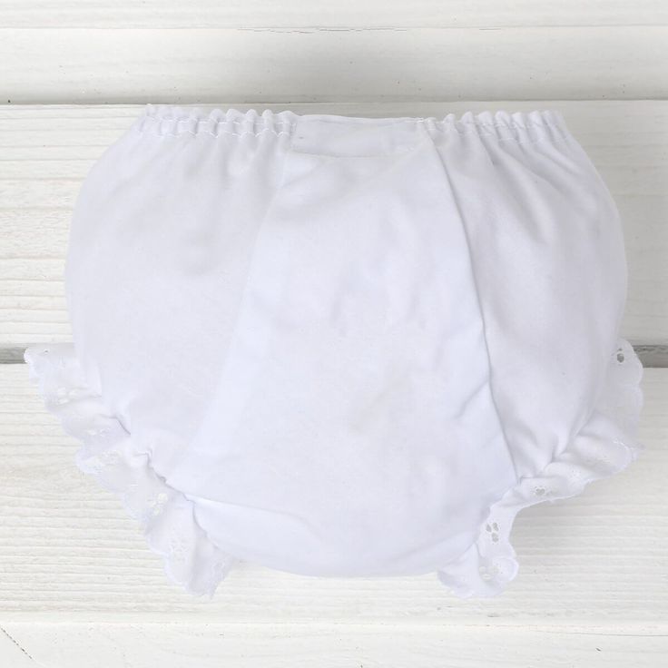 a white diaper cover sitting on top of a wooden floor