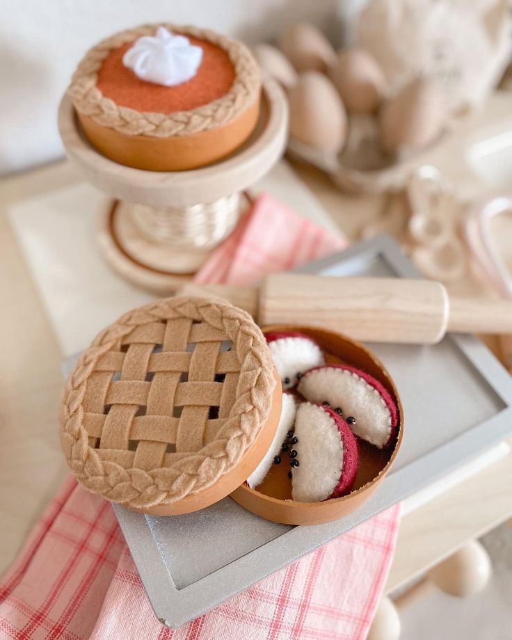 an assortment of desserts on a table with utensils and other items in the background